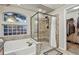 This bathroom features a separate tub and glass-enclosed shower with tiled walls and floors at 3534 Starry Night Loop, Castle Rock, CO 80109