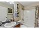 Full bathroom featuring shower-tub combo, oak cabinets and decorative wall art at 3534 Starry Night Loop, Castle Rock, CO 80109