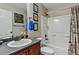 Full bathroom featuring shower-tub combo, oak cabinets and decorative wall art at 3534 Starry Night Loop, Castle Rock, CO 80109