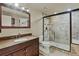 Bathroom featuring granite countertops, cherry cabinets, framed mirror, toilet, and glass enclosed shower at 3534 Starry Night Loop, Castle Rock, CO 80109