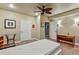 Bedroom features a bed, ceiling fan, glass table and multiple interior doors at 3534 Starry Night Loop, Castle Rock, CO 80109