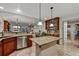 Spacious kitchen featuring granite countertops, stainless steel appliances, a central island, and tile floors at 3534 Starry Night Loop, Castle Rock, CO 80109