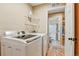 Functional laundry room with side-by-side washer and dryer with folding rack at 3534 Starry Night Loop, Castle Rock, CO 80109