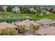 Scenic aerial view of homes overlooking a serene lake and lush green landscape with mature trees at 10067 Bluffmont Ct, Lone Tree, CO 80124