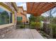 Outdoor patio featuring a concrete area, a wooden pergola with lights, and manicured landscaping at 10067 Bluffmont Ct, Lone Tree, CO 80124