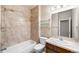 Well-maintained bathroom features a shower-tub combo, vanity with sink, and neutral tile surround at 10067 Bluffmont Ct, Lone Tree, CO 80124