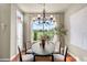 Dining room with golf course view, chandelier, large windows, and table at 10067 Bluffmont Ct, Lone Tree, CO 80124