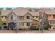 Attractive two-story home featuring stone accents, a covered patio, and a well-manicured lawn at 10067 Bluffmont Ct, Lone Tree, CO 80124