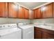 Laundry room with appliances, storage cabinets, a utility sink and a countertop at 10067 Bluffmont Ct, Lone Tree, CO 80124