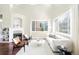 Bright living room with a fireplace, hardwood floors, and large windows that offer great views at 10067 Bluffmont Ct, Lone Tree, CO 80124