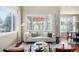 Cozy living room with hardwood floors, large windows, and comfortable seating arrangements at 10067 Bluffmont Ct, Lone Tree, CO 80124