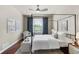 Bedroom with hardwood floors, a four-poster bed, a ceiling fan, and a large window at 10067 Bluffmont Ct, Lone Tree, CO 80124