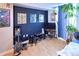 View of bedroom with dark accent wall and electric guitar at 1196 N Grant St # 104, Denver, CO 80203