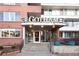 Apartment building entrance with brick facade, prominent signage, and well-lit entrance, creating a welcoming atmosphere at 1196 N Grant St # 104, Denver, CO 80203