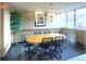 Bright conference room featuring a large oval table, seating for six, and an abundance of natural light from big windows at 1196 N Grant St # 104, Denver, CO 80203