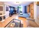 Well-lit living space with hardwood floors, a glass coffee table, and a cozy Murphy bed tucked away in the corner at 1196 N Grant St # 104, Denver, CO 80203