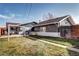 A spacious backyard with a walkway, covered patio, lawn area, and privacy fence offers ample outdoor space at 4070 W Exposition Ave, Denver, CO 80219