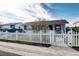 Charming single story home with white picket fence and lush yard creating a welcoming curb appeal at 4070 W Exposition Ave, Denver, CO 80219