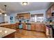 A view of the kitchen with stainless steel appliances, wooden cabinets, and hardwood flooring at 4070 W Exposition Ave, Denver, CO 80219