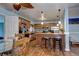 Modern kitchen featuring custom cabinetry, granite countertops, stainless steel appliances, and bar seating at 4070 W Exposition Ave, Denver, CO 80219