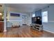 Cozy living room featuring hardwood floors, bright paint and ample natural light from nearby windows at 4070 W Exposition Ave, Denver, CO 80219