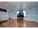 Inviting living room with hardwood floors, neutral walls, and comfortable seating by the front door at 4070 W Exposition Ave, Denver, CO 80219