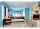 A view of the bedroom, featuring blue walls, a carpet floor, and large windows at 4070 W Exposition Ave, Denver, CO 80219