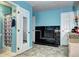A view into the primary bedroom that leads into the bathroom with an adjacent fireplace at 4070 W Exposition Ave, Denver, CO 80219