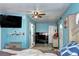 A view of the bedroom with blue walls, a ceiling fan, and an entertainment center at 4070 W Exposition Ave, Denver, CO 80219