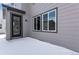 A new home has a back porch with a door and large windows at 13531 E 99Th Pl, Commerce City, CO 80022