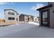 A view of the backyard with a snow covered ground and modern homes at 13531 E 99Th Pl, Commerce City, CO 80022