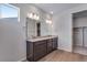 A double vanity bathroom with wood floors features a large mirror and granite countertop at 13531 E 99Th Pl, Commerce City, CO 80022