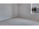 This is a neutral bedroom with soft carpeting and a bright window at 13531 E 99Th Pl, Commerce City, CO 80022