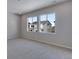 Sunlit bedroom featuring soft gray carpet, recessed lighting, and neighborhood views at 13531 E 99Th Pl, Commerce City, CO 80022