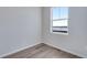 Cozy bedroom featuring neutral walls, hardwood floors, and a bright window view at 13531 E 99Th Pl, Commerce City, CO 80022