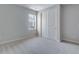 A bright bedroom with soft gray carpet and a spacious closet with double doors at 13531 E 99Th Pl, Commerce City, CO 80022