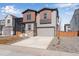 Charming two-story home with neutral siding, stone accents, and a two-car garage at 13531 E 99Th Pl, Commerce City, CO 80022