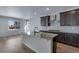 Bright kitchen features granite counters, stainless steel appliances and an island with sink at 13531 E 99Th Pl, Commerce City, CO 80022
