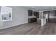 Modern kitchen features stainless steel appliances, gray cabinets, and an open floor plan at 13531 E 99Th Pl, Commerce City, CO 80022