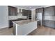 Gourmet kitchen boasts an island, stainless appliances, and dark cabinets at 13531 E 99Th Pl, Commerce City, CO 80022