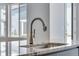 A close up of the kitchen sink featuring a modern faucet and granite countertop at 13531 E 99Th Pl, Commerce City, CO 80022