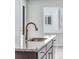 Modern kitchen sink with granite countertops, stainless steel faucet, and a nearby view of the window at 13531 E 99Th Pl, Commerce City, CO 80022