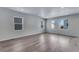 Bright living room featuring luxury vinyl plank flooring and large windows for ample natural light at 13531 E 99Th Pl, Commerce City, CO 80022
