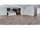 Spacious living room with an open floor plan adjacent to modern kitchen with stainless appliances at 13531 E 99Th Pl, Commerce City, CO 80022