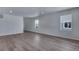Bright living room with hardwood floors and ample natural light from multiple windows at 13531 E 99Th Pl, Commerce City, CO 80022