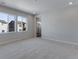 A spacious main bedroom provides natural light, carpet floors, and access to a bathroom at 13531 E 99Th Pl, Commerce City, CO 80022