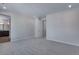 An open main bedroom is adjacent to the bathroom, featuring soft, neutral carpets at 13531 E 99Th Pl, Commerce City, CO 80022