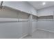A large walk-in closet is carpeted and provides ample space and storage shelving at 13531 E 99Th Pl, Commerce City, CO 80022