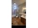 Bathroom featuring updated fixtures, vanity, and a shower-tub combo with tiled walls at 914 E Iowa Ave, Denver, CO 80210