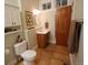 Traditional bathroom features a single vanity, storage cabinet and a wooden door at 914 E Iowa Ave, Denver, CO 80210